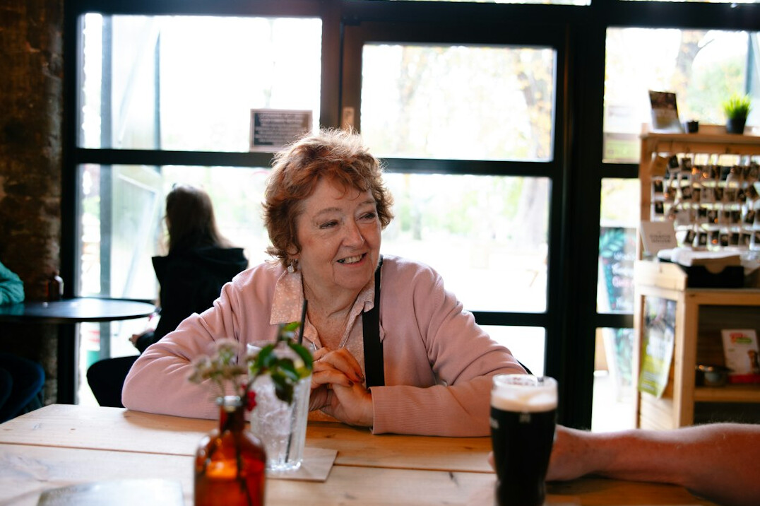 senior woman smiling at table