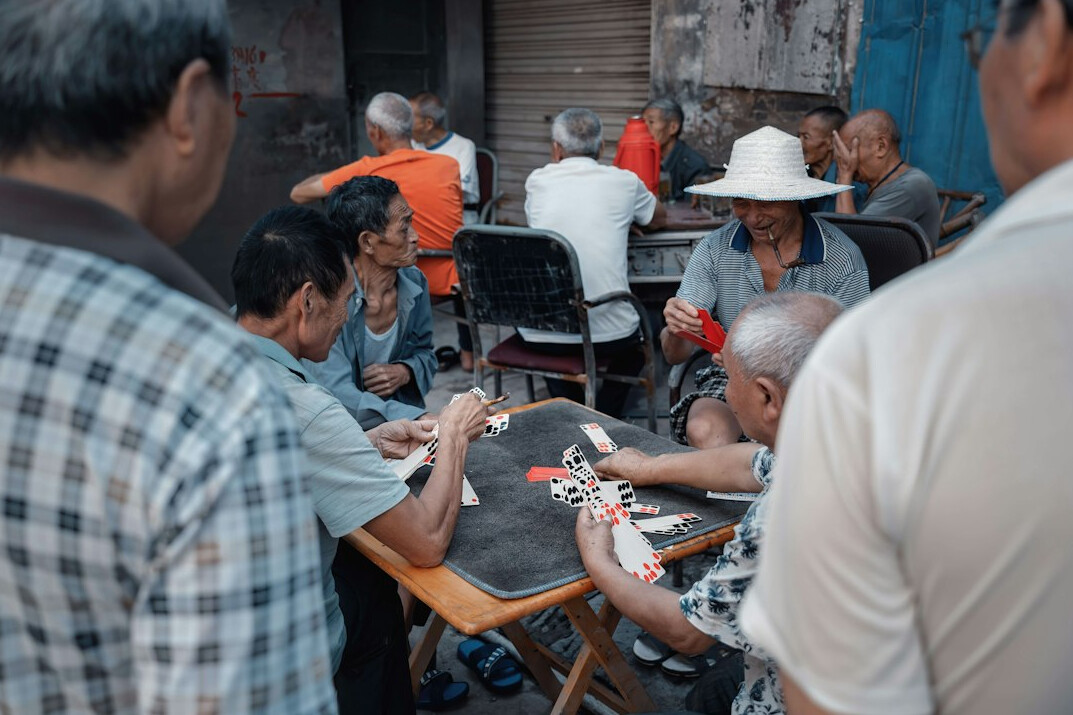 elderly people playing cards