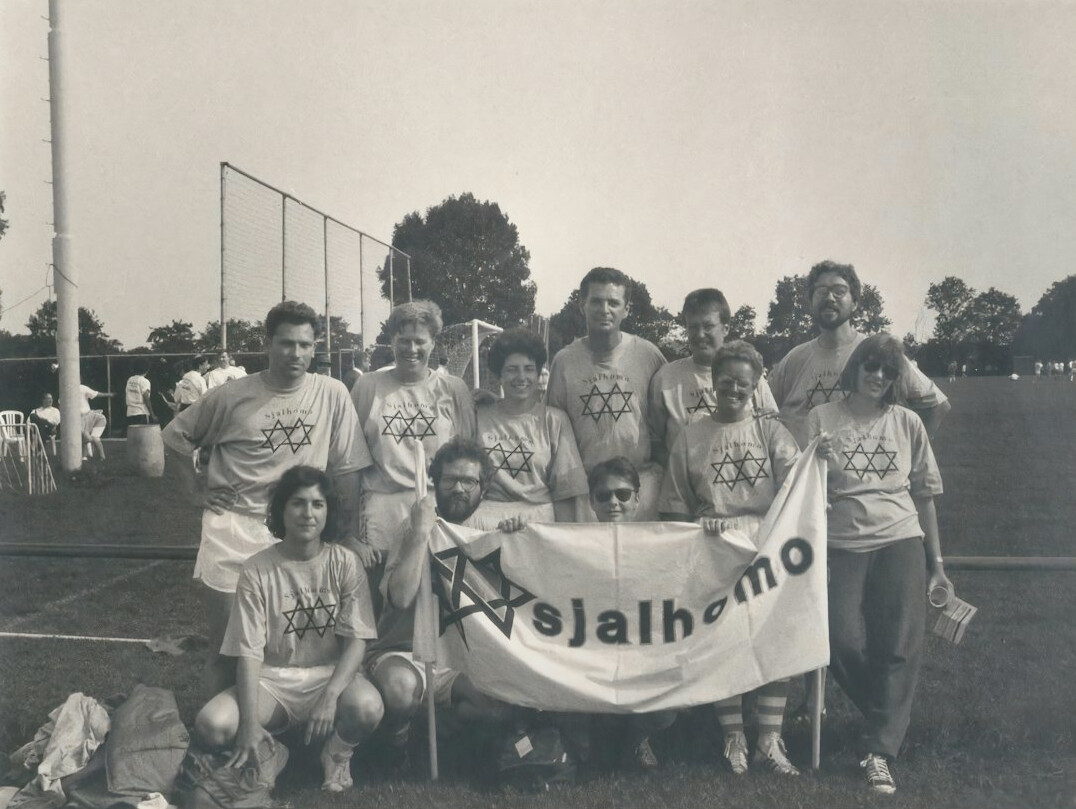 Volunteers and senior club members standing together smiling